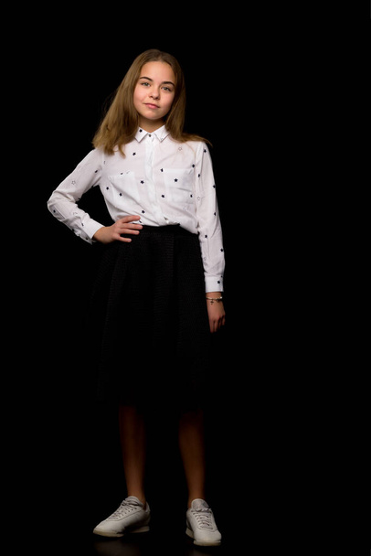 Fashionable girl teenager studio photo on a black background. - Фото, изображение