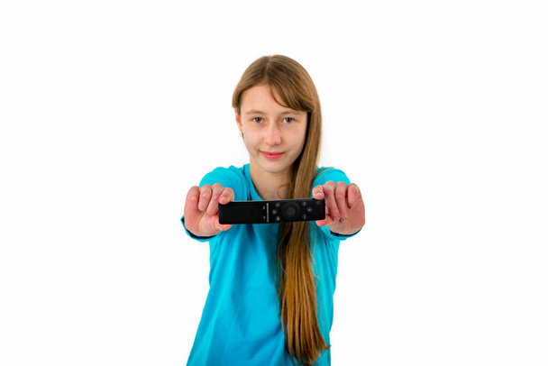 Girl kid child holds tv remote control.White studio wall.Closeup. - Photo, Image