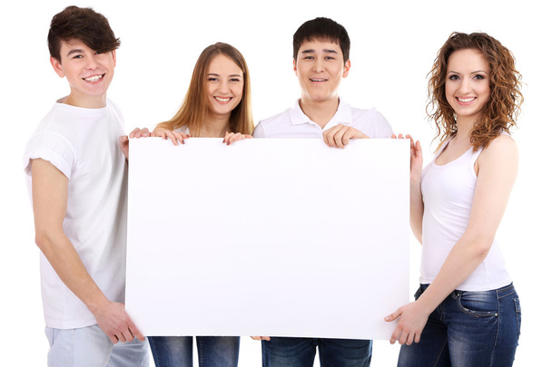 Group of happy young people holding blank poster isolated on white - Фото, зображення