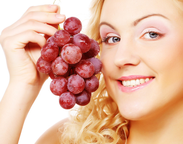 Mujer rubia joven con uva
 - Foto, imagen