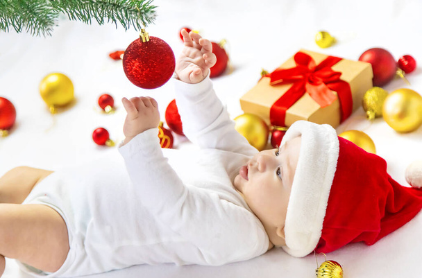 Christmas photo of baby with New Year's decor. selective focus. holiday. - Φωτογραφία, εικόνα