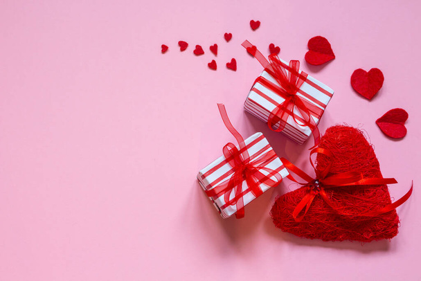 Valentine's day. Red heart with gift boxes on pink background. flat lay with copy space - Foto, immagini