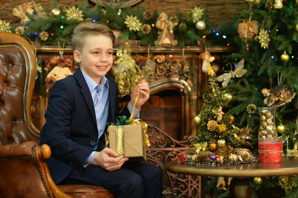 Portrait of little boy with gift   on  Christmas - Фото, изображение