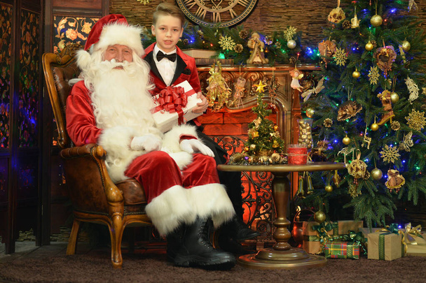 Santa Claus and happy boy with gift  - Фото, изображение