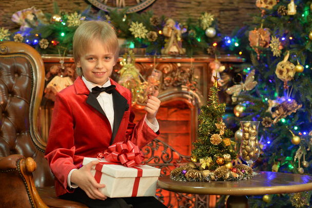 Portrait of little boy with gift  on Christmas - 写真・画像