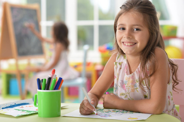  cute smiling girl drawing at home - Фото, зображення