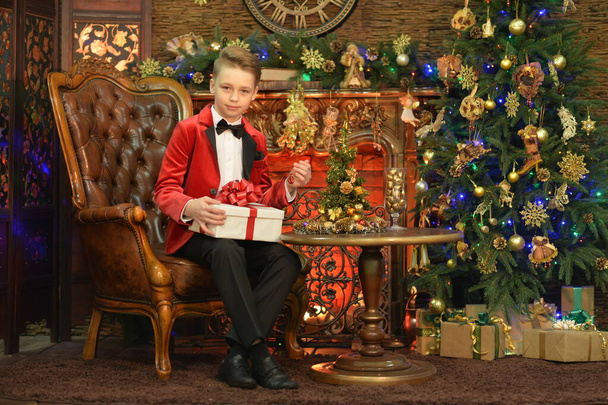 Portrait of little boy with gift on Christmas - 写真・画像
