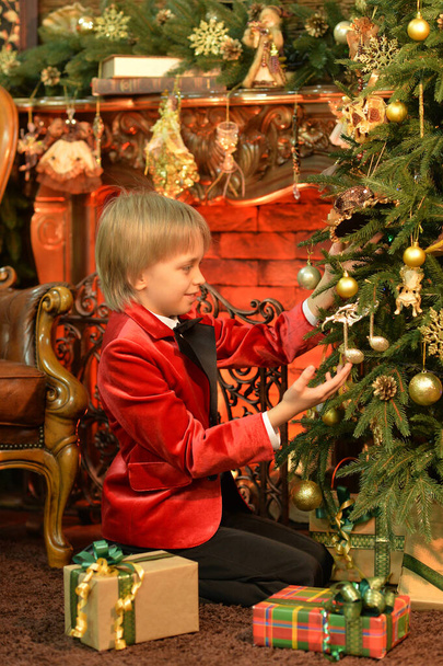 cute boy posing near Christmas tree - Zdjęcie, obraz