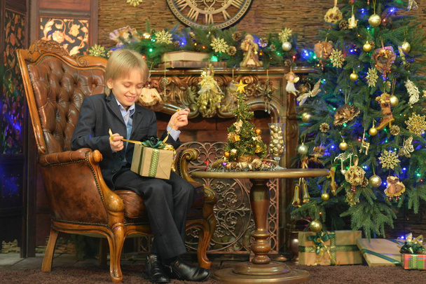 Portrait of little boy with gift on Christmas - Zdjęcie, obraz
