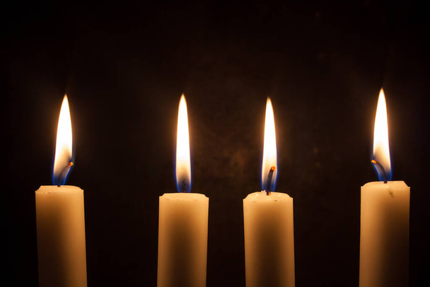 Four candles in a row burning with flame - Foto, Imagem