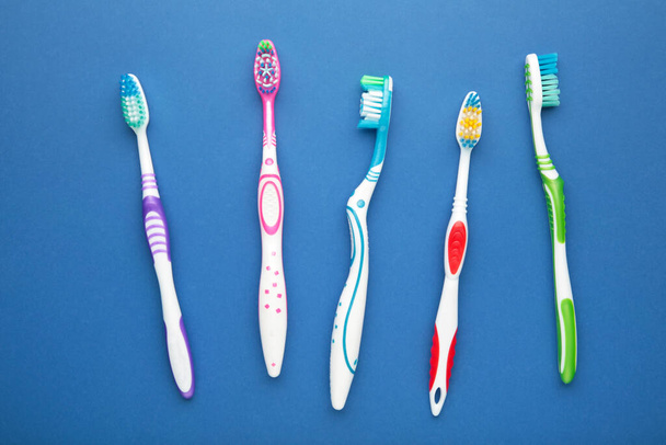 Toothbrushes on a dark blue background. Top view - Φωτογραφία, εικόνα
