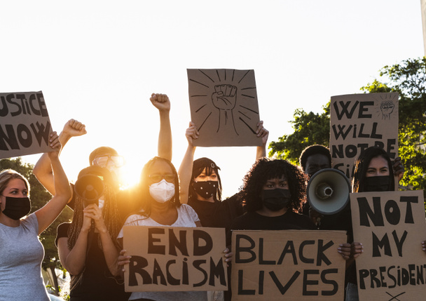 Activist movement protesting against racism and fighting for equality - Demonstrators from different cultures and race protest on street for equal rights - Black lives matter protests city concept - Photo, Image
