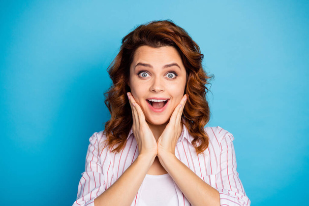 Closeup photo of pretty wavy foxy lady hold arms on cheeks cheerful good mood open mouth listen crazy news staring wear white striped shirt isolated bright blue color background - Foto, imagen