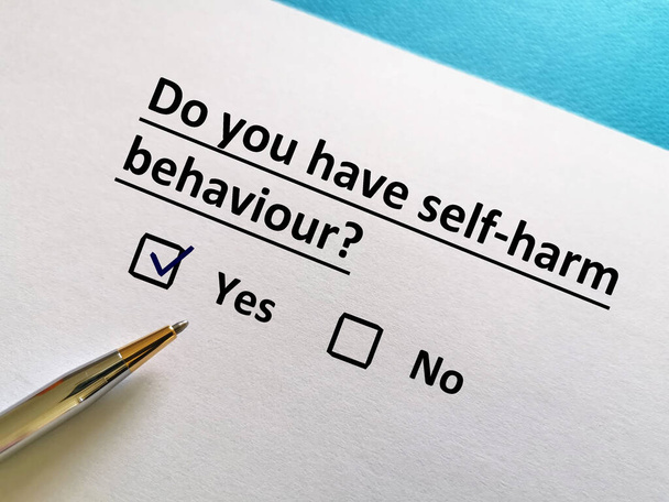 One person is answering question. He has self harm behaviour. - Photo, Image