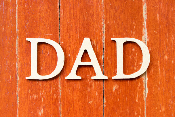 Alphabet letter in word dad on old red color wood plate background - Φωτογραφία, εικόνα