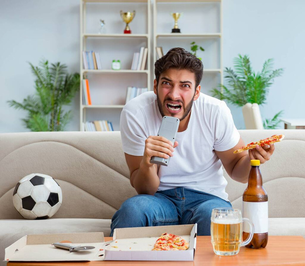 Man eating pizza having a takeaway at home relaxing resting - Photo, Image