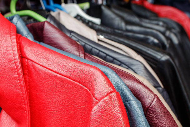 leather jackets hanging on a hanger in the city market outdoor on autumn day - Photo, Image