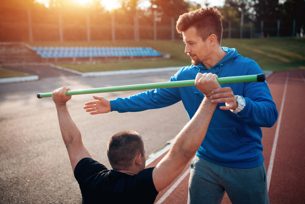 sport man has workout or exercising outdoor with personal fitness trainer - Valokuva, kuva
