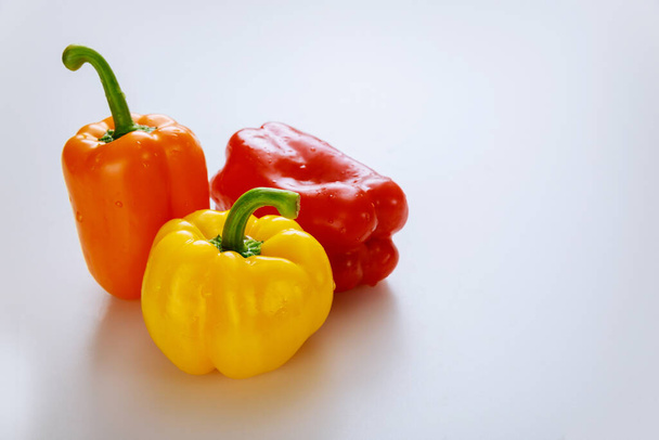 Red, orange and yellow bell peppers isolated on white background. Copy space. - Photo, Image