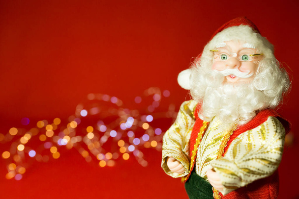New Year and Christmas card on a red background. Santa Claus and Christmas lights. - Photo, Image