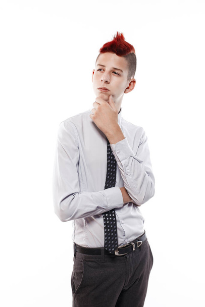Portrait of serious teen with red mohawk wearing shirt and tie while looking at camera. Isolated. - Foto, Bild