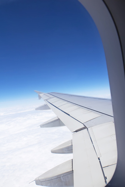 Airplane window looking out over the wing - Φωτογραφία, εικόνα