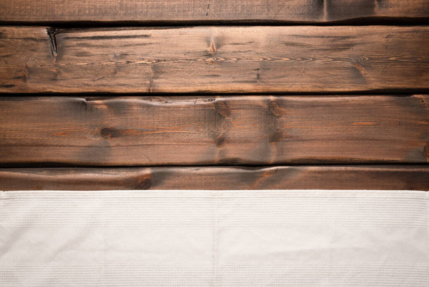 White towel on the brown wooden table background with copy space top view. - Foto, imagen