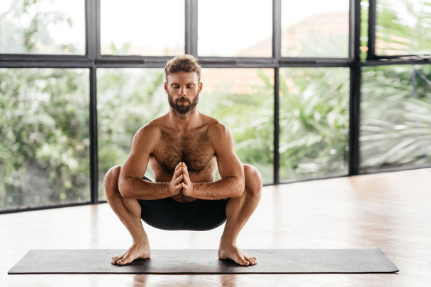 Yoga men workout in studio in front of a window - Photo, image