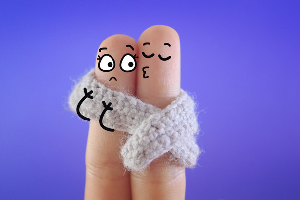 Two fingers are decorated as two person. They are sharing a scarf when they are dating. - Photo, Image