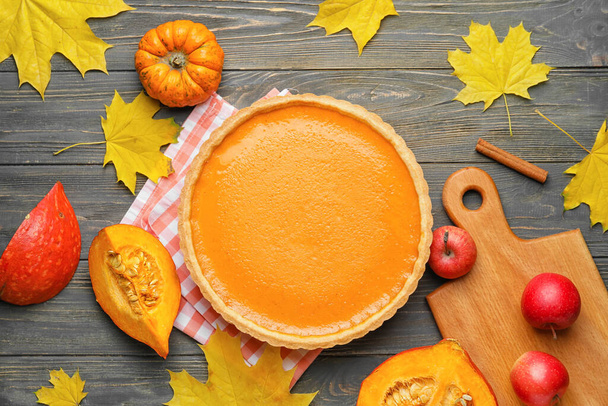 Composition with tasty pumpkin pie on wooden background - Фото, зображення
