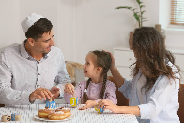 Happy family celebrating Hannukah at home - Фото, изображение