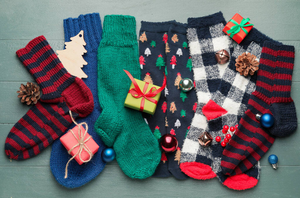 Warm socks and Christmas decor on wooden background - Фото, зображення