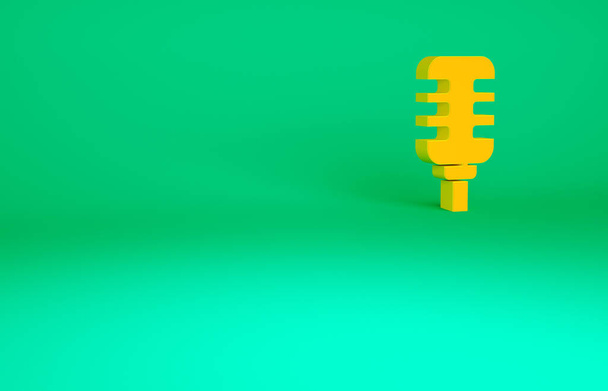 緑の背景に隔離されたオレンジマイクのアイコン。無線マイクで。スピーカーサイン。最小限の概念。3Dイラスト3Dレンダリング. - 写真・画像