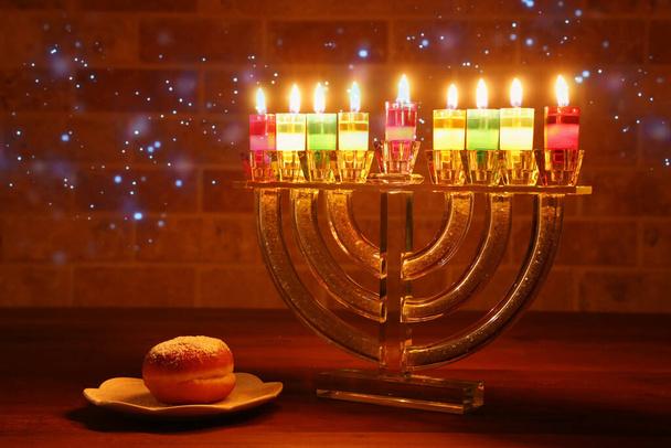 image of jewish holiday Hanukkah background with crystal menorah (traditional candelabra) and oil candles - Foto, afbeelding