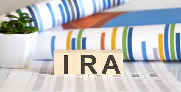 IRA on wooden blocks on the table with different color graphs - Photo, Image