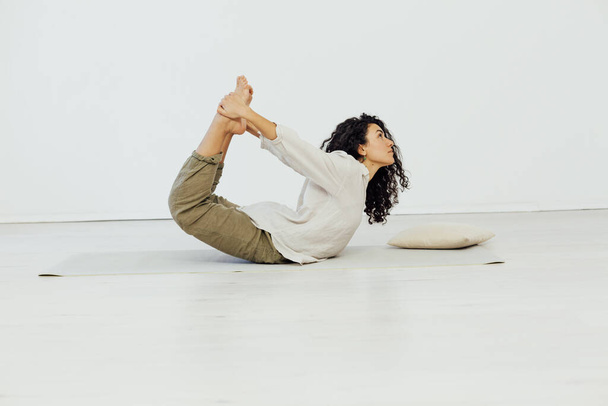 Brunette woman engaged in yoga asana gymnastics flexibility body - Valokuva, kuva