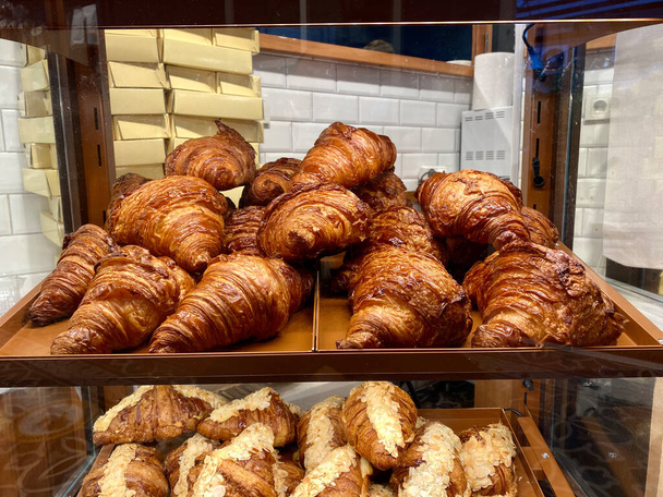 Croissants for Sale on Glass and Wooden Showcase Display at Bakery Shop. Ready to Eat and Serve. - Foto, immagini