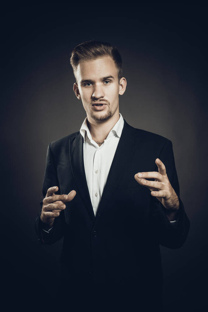 Young man dressed in suit studio portrait - Фото, изображение