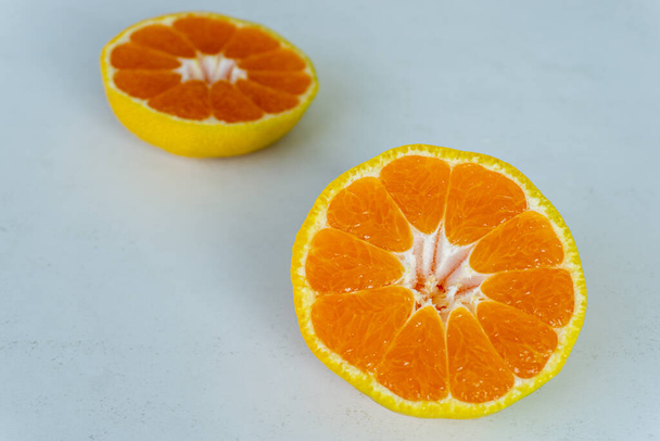 Tangerine cut in half on a white background - Fotoğraf, Görsel