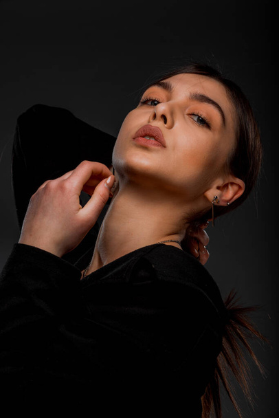 Attractive young female model posing in stylish black jacket - Фото, зображення