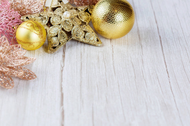 Christmas balls and decorations on a light wooden background with copy space. - Fotó, kép