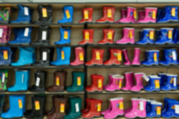 childrens bright shoe store with a large selection of colors, models and sizes, blurred and defocused - Fotó, kép