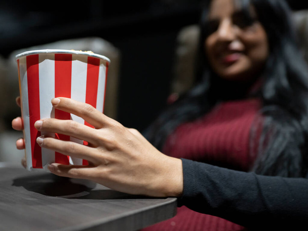 woman eating popcorn at the cinema - Fotó, kép