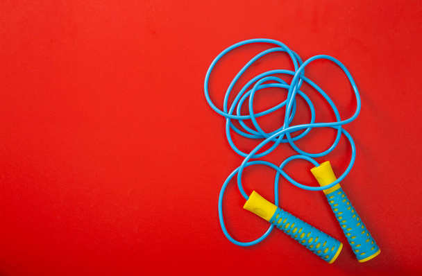 Minimalism fitness concept. Skipping rope on color background. Top view - Photo, Image