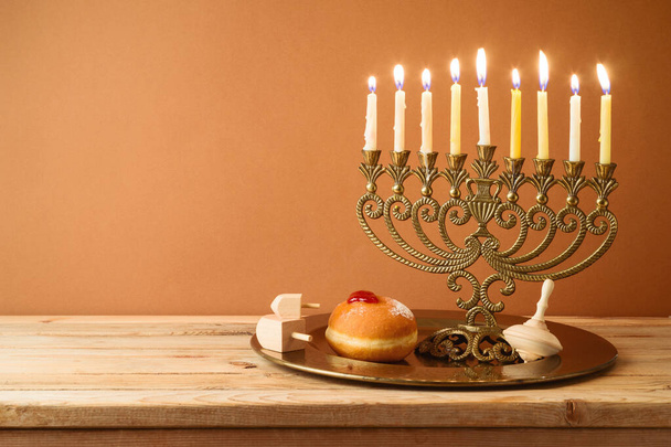 Jewish holiday Hanukkah concept with vintage menorah and candles on wooden table - Foto, Bild
