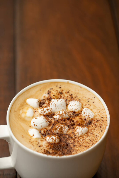 Overhead angle photo cup o hot cocoa with marshmallows and cinnamon sprinkled - Photo, Image