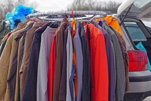 Car boot sale second hand clothing at railing - Photo, Image