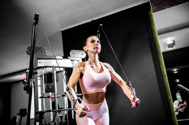 young woman in sportswear with barbell in gym - Zdjęcie, obraz