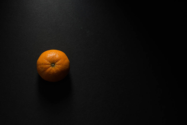 A top view of an orange isolated on a black background - 写真・画像