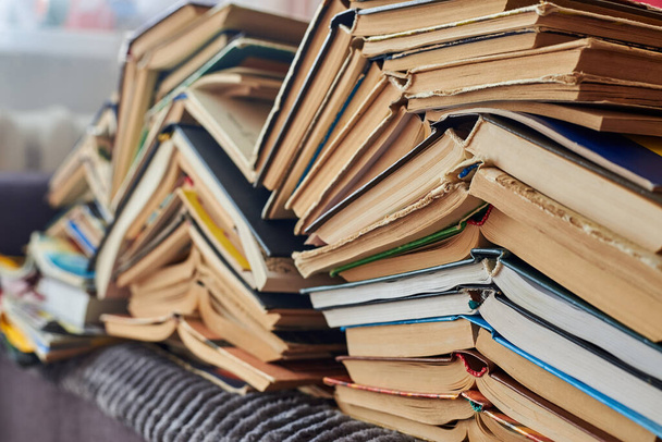 Old books piled up in a heap, close-up, learning and education concept. - Photo, Image